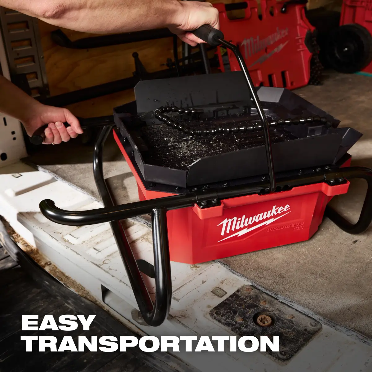 Carrying the sealed oiler basin by its handle to a van