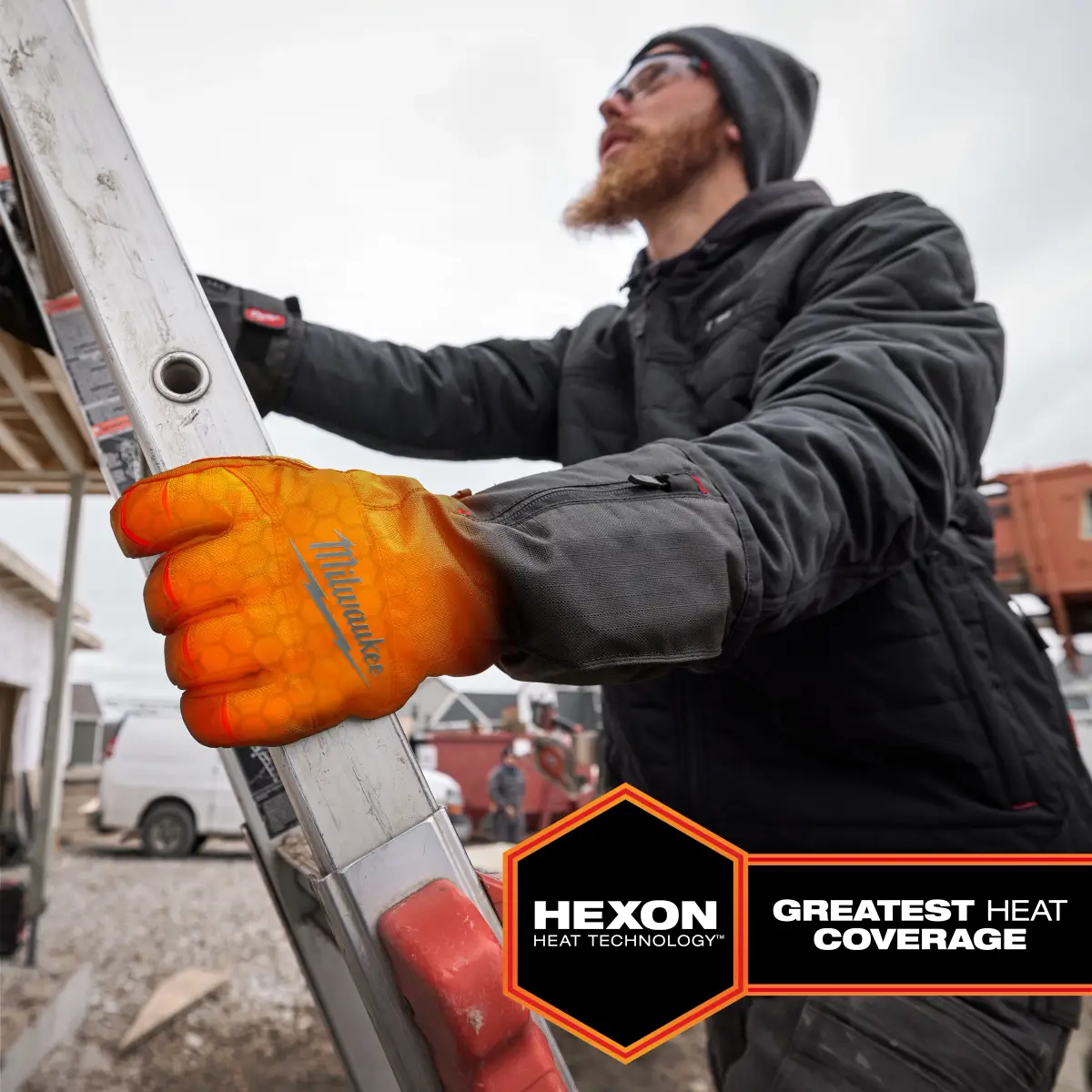 Worker gripping a ladder with a heated glove on one hand