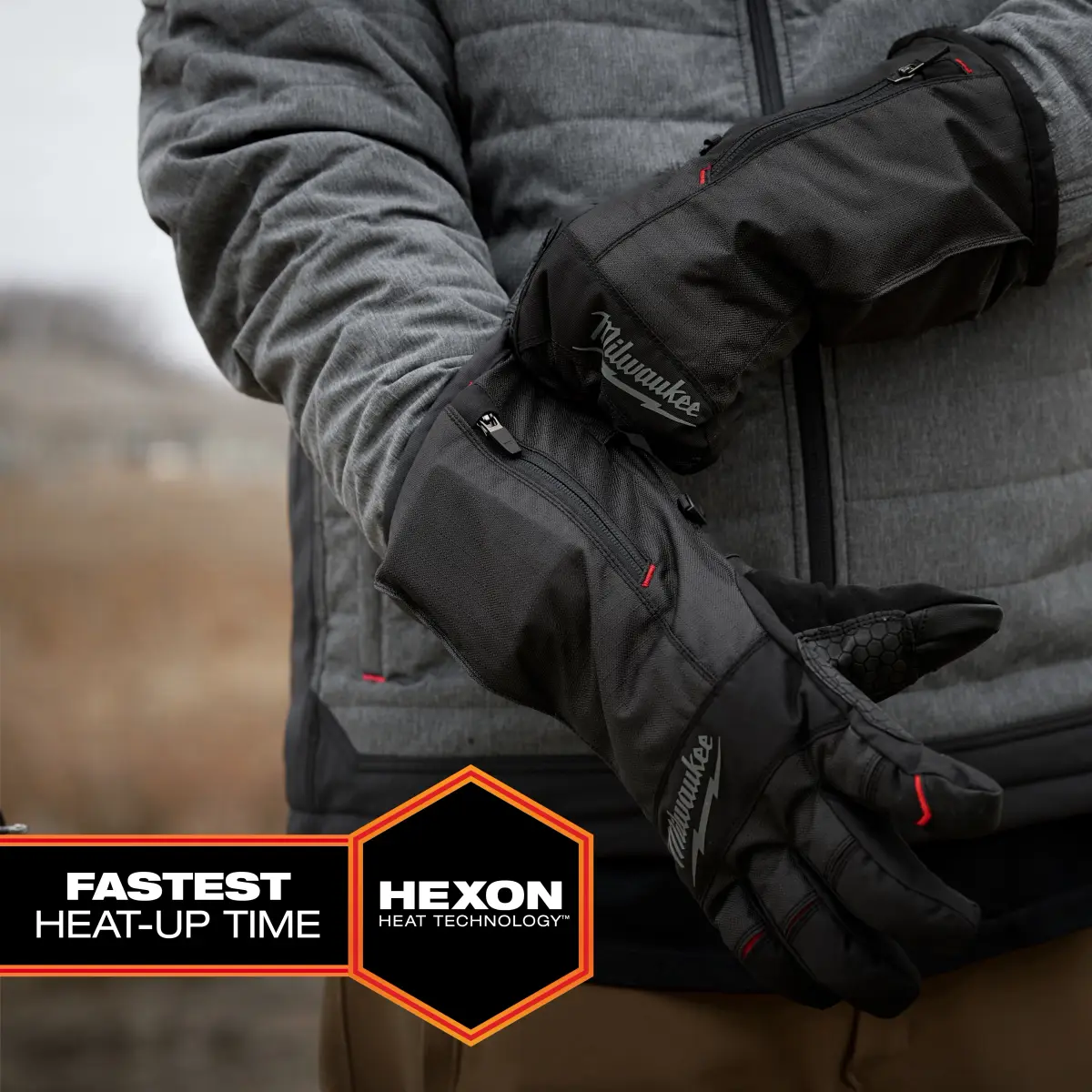 Heated glove worn outdoors with the side zipper visible